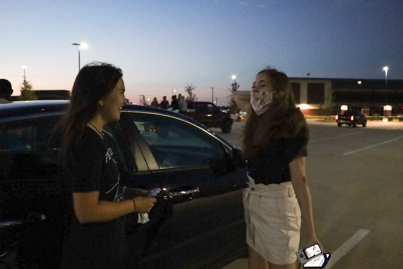 PHS senior Kayli Cook and RHHS senior Nikki Hansen catch up during the Senior Sunrise. The event started at 6:30 a.m. Tuesday morning. Students parked at Children's Health Stadium to watch the sunrise while Student Council offered donuts and refreshments.