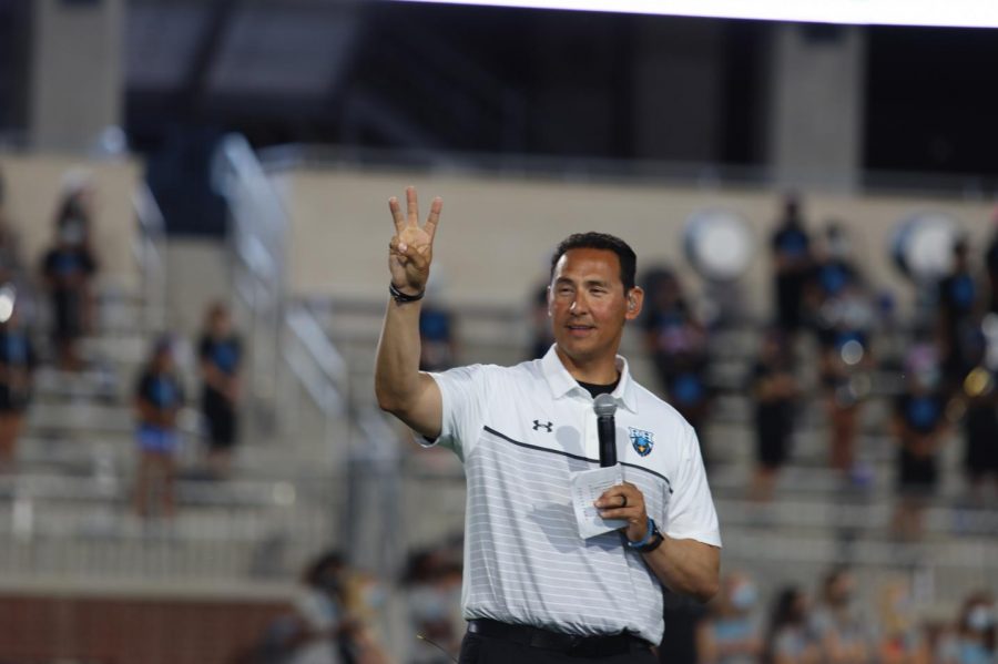 Athletic coordinator and football coach Mark Humble holds up the Rock Hill claw during the Meet the Blue Hawks event. Football will have their first game against Frisco Heritage Thursday, Sept. 24. The game will be away, and kick-off will start at 7 p.m.