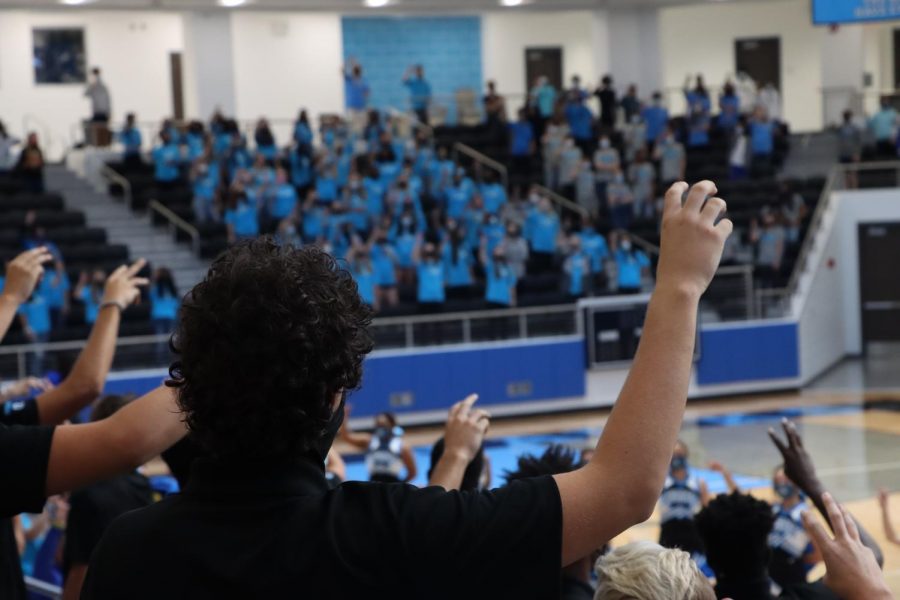 Students put their claws in the air while the band plays the school song. Due to confirmed COVID cases, only athletics and student performers could attend the first pep rally. In addition to the game, the Oct. 2 pep rally has been canceled for safety concerns.