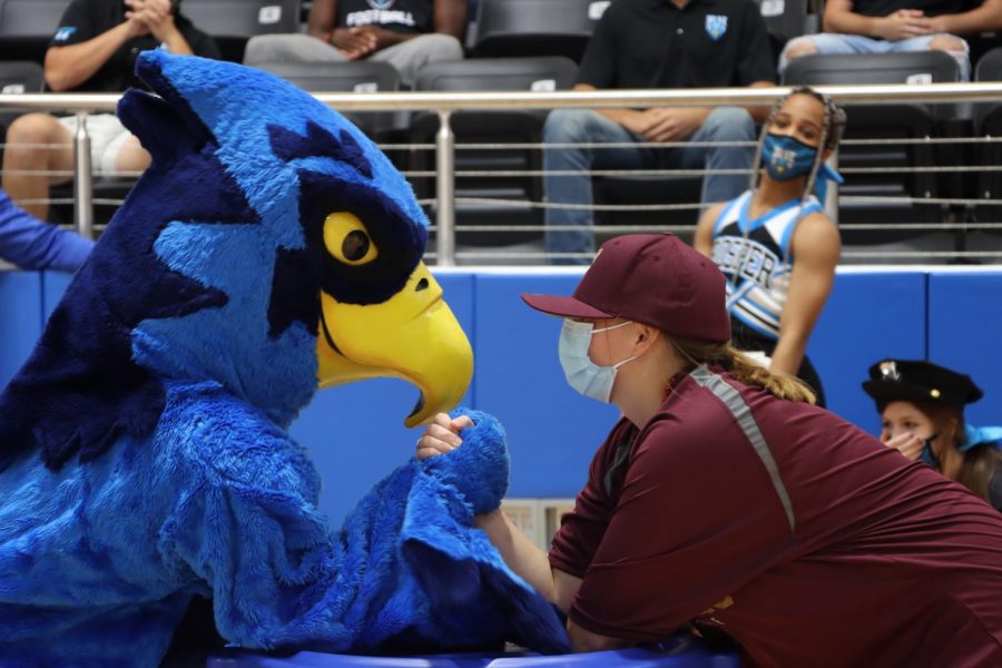 Mascot Rocky arm wrestles a student dressed as a Frisco Heritage fan. Cheer performed a brand new routine at the "Blue-Out" pep rally. The Blue Hawks lost to Frisco Heritage 35-61.