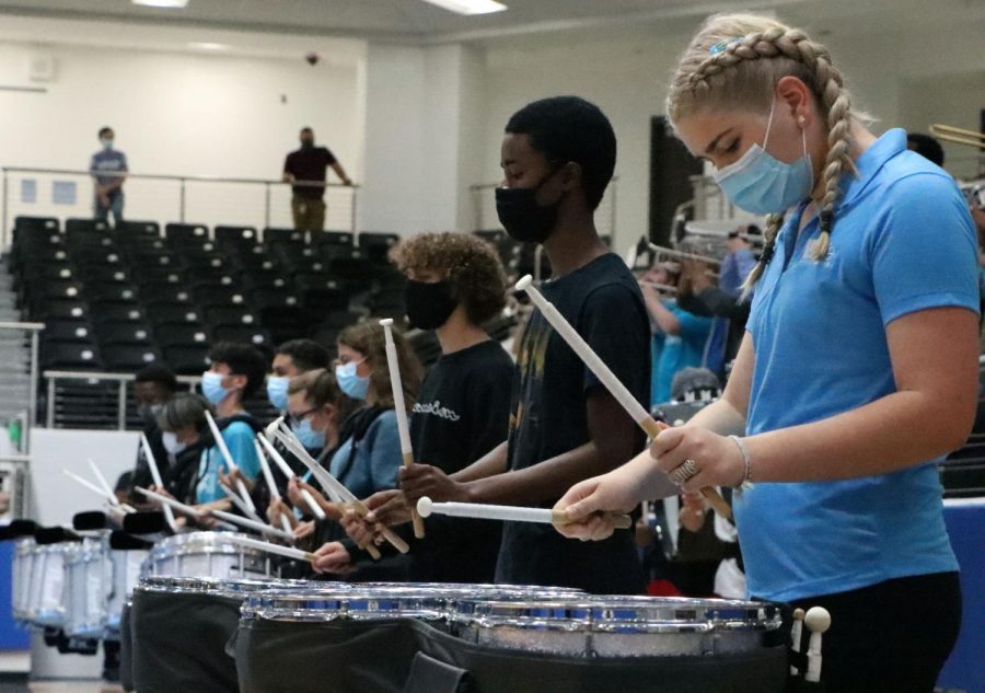 The drum line plays the school song towards the end of the Sept. 24th pep rally. Although the arena seats were mostly empty, band, cheer and drill team performed for fall athletics. "Students just being here is support," football coach and athletic coordinator Mark Humble said. "You look around already, and our kids are doing an amazing job. Wearing your Blue Hawks shirts are always good to see."