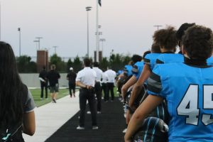 Football players listen to the national anthem at the first home game of the season. Football had to cancel a couple games for COVID-19 concerns. The Forthcoming football game will be played at Children's Health Stadium this Friday, Oct. 23.