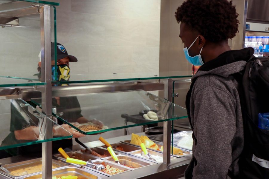 Senior Shaun Nganga orders his lunch at the taco line. "The only reason I would advise any of you guys to come and eat," cafeteria worker Maria Romo said. "Is because of the Mexican delicious food we make daily fresh."