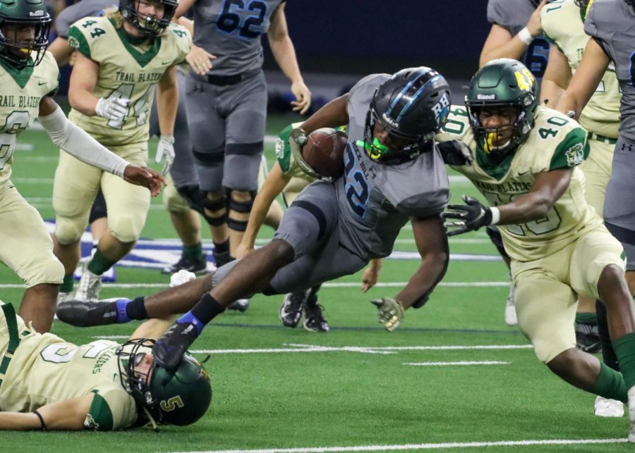 Junior Donovan Shannon runs through Trail Blazers players at Rock Hill's last game Friday. The Blue Hawks lost 48-28. The team played at The Star at Frisco. 