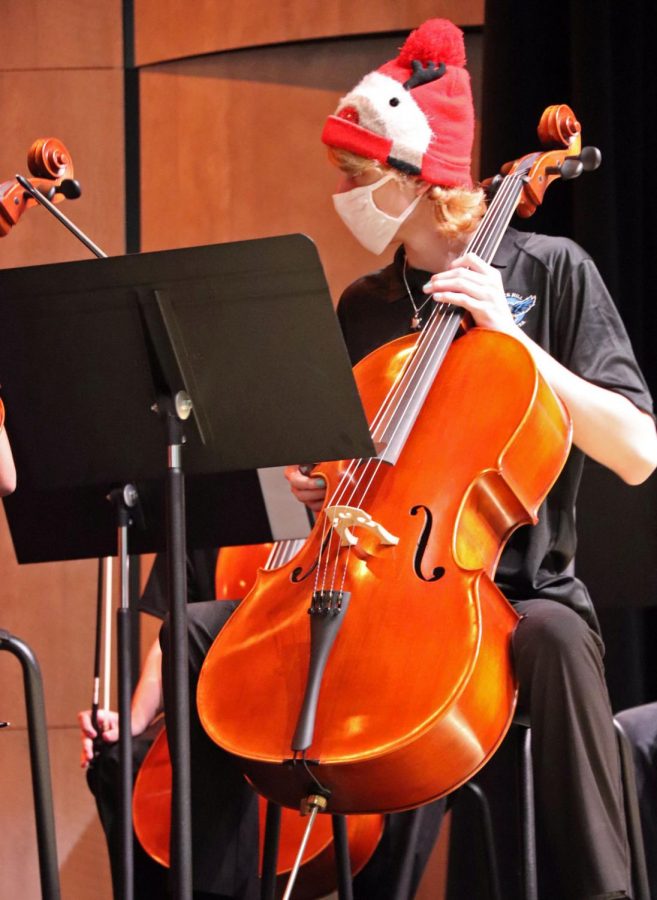 Orchestra student Connor Brooks plays his cello for parents and students at the Christmas Concert. Members wore holiday hats and accessories throughout the Thursday-night show. The event took place in the brand-new auditorium.