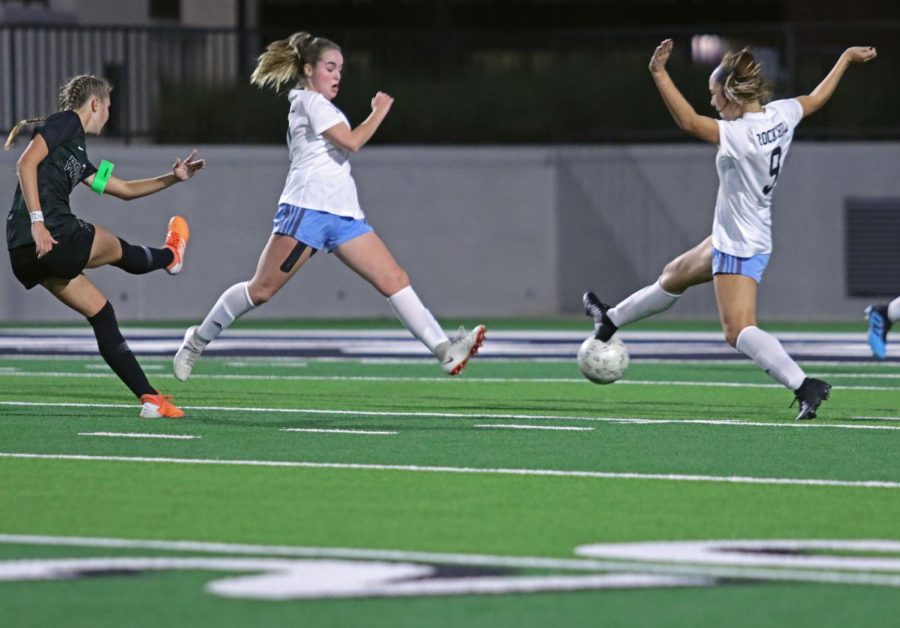 Sophomore and defender Avery Wheeler jumps with teammate to block the ball from Prosper player. This was the district's first time having Prosper and Rock Hill teams compete against one another. The team lost 0-2.