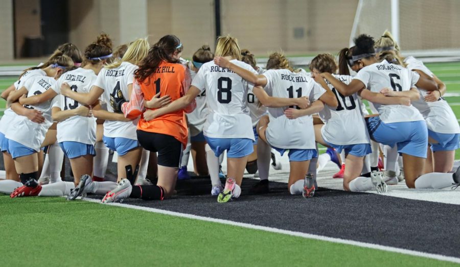 The team huddles up before the start of the game. The girls played against PISD school, Prosper. The game took place at Children's Health Stadium at 7 p.m.