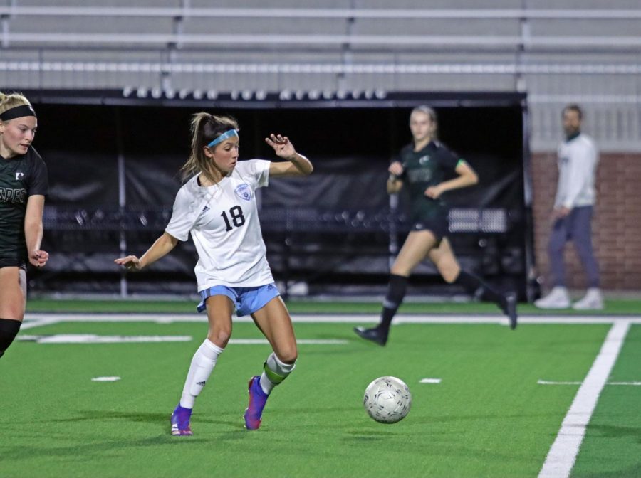 Sophomore forward Noemi Mistretta runs for the ball while surrounded by Prosper players. Although the team lost 0-2, this was Rock Hill athletic's first game against a Prosper team. Parents and fans gathered in the stadium with masks and COVID-19 precautions. 