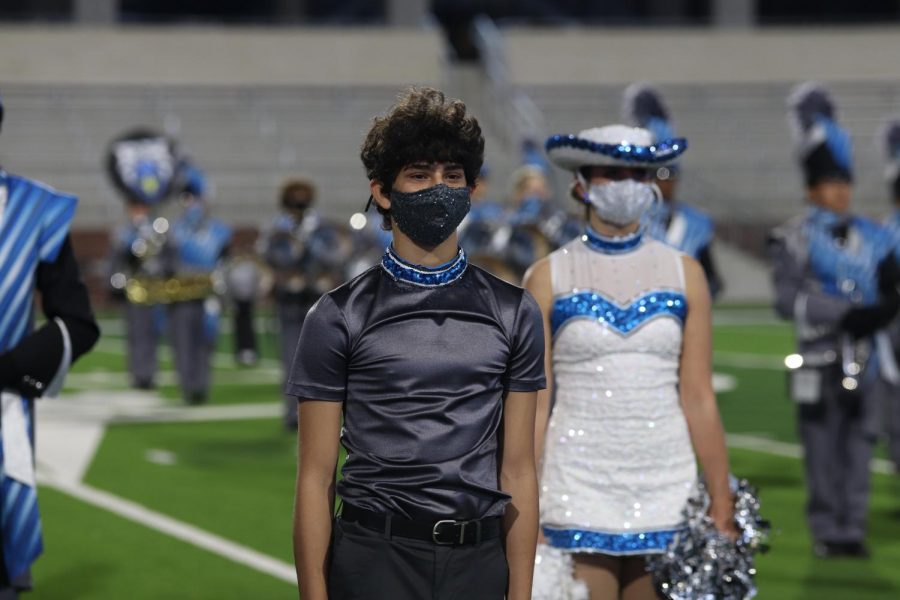 Rockette Rami Shihabi stands with his teammates on the field at Children's Health Stadium. This is Shihabi's first year on the drill team. 