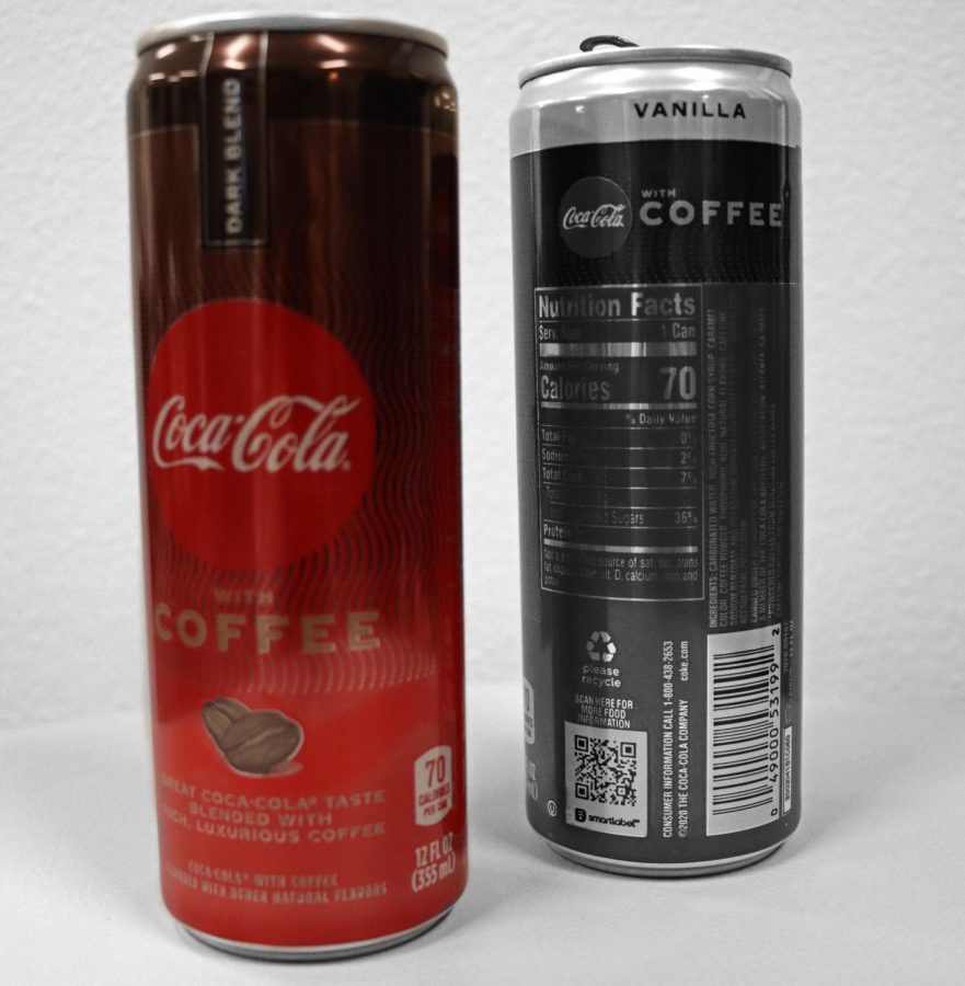 A stylized photo features  two cans of Coca-Colas' new product, Coca-Cola with Coffee. Columnist Wesley Barrett takes a look at the the new combination in the following review. "Despite rational first impressions of distaste, the flavor of the drink is nuanced, and actually quite good," Barrett said. "Each sip is a perfectly choreographed cycle from from beginning to end."