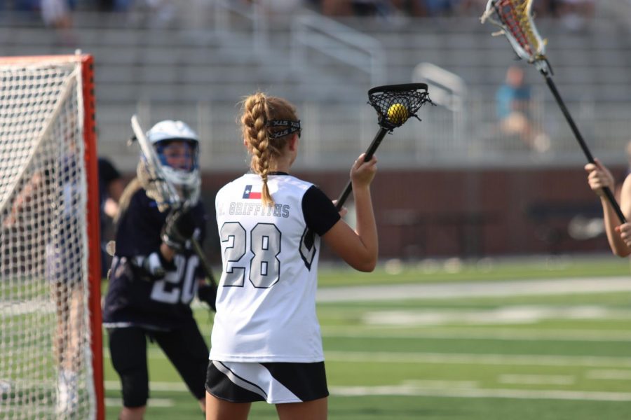 Junior Mallory Griffiths prepares to throw the ball to a teammate during a lacrosse match for the integrated Prosper team. The team is one of the only teams with both Rock Hill and Prosper students. "Even though we are two separate schools," Griffins said. "I still think that we come to play together as one."  