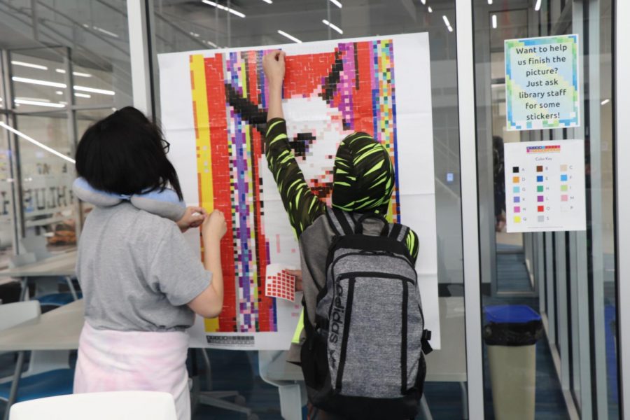 Freshman Crystal Nguyen and (?????) completing a mosaic activity in the library. "The librarian just came to me and all my friends in the morning and asked if we wanted to do this," Nguyen said, "I just they do have more of this because it's really fun and really pass by the time."