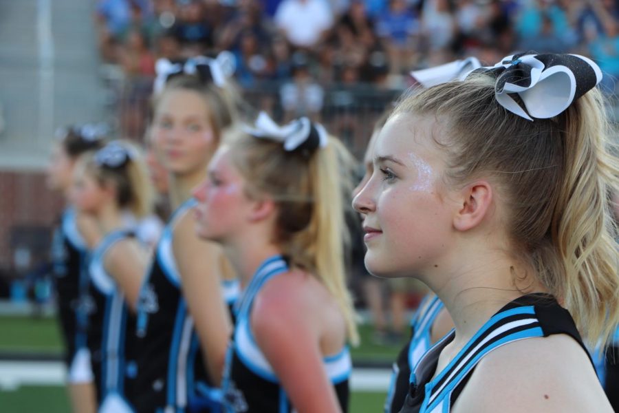 Cheerleaders watching the hype video.