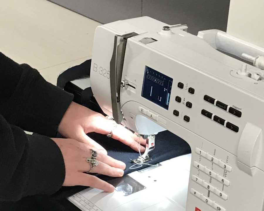 Junior Emma Palmese sews for a project in the school's fashion room. "I honestly think more people should get into sewing. It's less wasteful. Some people throw away shirts if they need a button sewn." The fashion department took in clothing donations from students to use for their spring fashion show, opting for a more sustainable production.