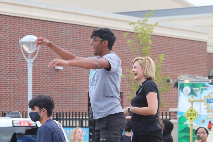 Senior Gautham Janyavula and Prosper ISD superintendent Dr. Furguson toss candy to the community members surrounding RHHS. "Throwing candy with Dr. Furguson was one of the most memorable moments of my high school experience so far," said Janyavula. The float consisted of the top-ranked senior class students and Prosper ISD staff.