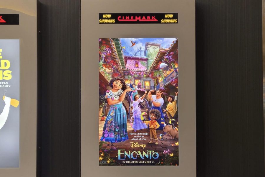 A promotional poster for “Encanto,” which premiered on Nov. 24, is displayed inside a local movie theater. The movie’s themes focus on family, tradition and belonging in accordance with typical end-of-the-year spirit. Staff writer Nanditha Nagavishnu reviews the movie, saying its “flowery color palette and rosy soundtrack” make it a fun watch.