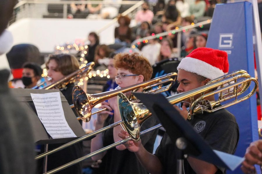 Band member and senior Mateo Lannaman performs the trombone at the Winter Extravaganza. "My favorite part of the Winter Extravaganza is the tradition of playing Sleigh Ride every year," junior and band member Jade Cummings said. Rock Hill band performed at their annual winter concert on Dec. 14 in the auditorium.