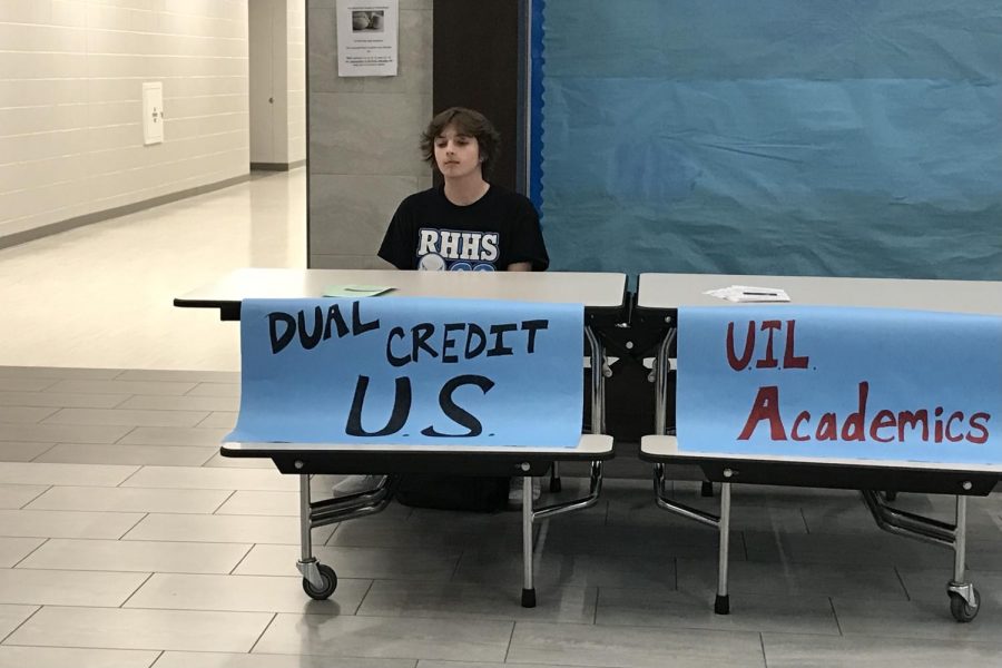 RHHS junior Ethan Malcolm attends the booth for Dual Credit U.S. history at the EXPO Night on Jan. 19, ready to answer attendee questions about the course. The event highlighted clubs and course options for RHHS students and parents to weigh their choices. “Dual Credit is a great way to fulfill high school course requirements and college credits at the same time,” Malcolm said.