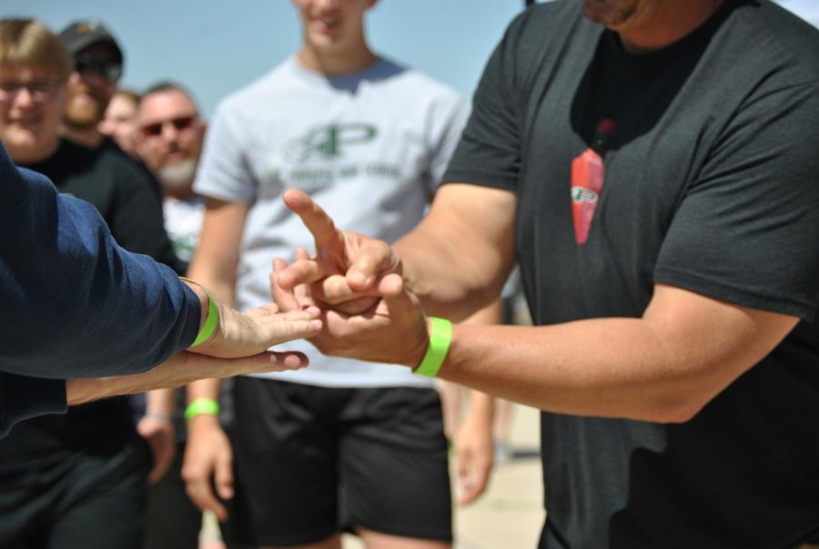 During the final face-off, PHS Coaches and Chief Blasingame played a round of "rock, paper, scissors, shoot" to see who would pull the truck first. "I would say [training would] just [be] like, pulling something that's like really heavy," Rodriguez said, "Like my bed, it's on carpet, and so it's easy for me in a way. But then, yet again, it's not 75,000 lbs." The winner of the brief game was the PHS football coaches, so they competed in their final pull first. 