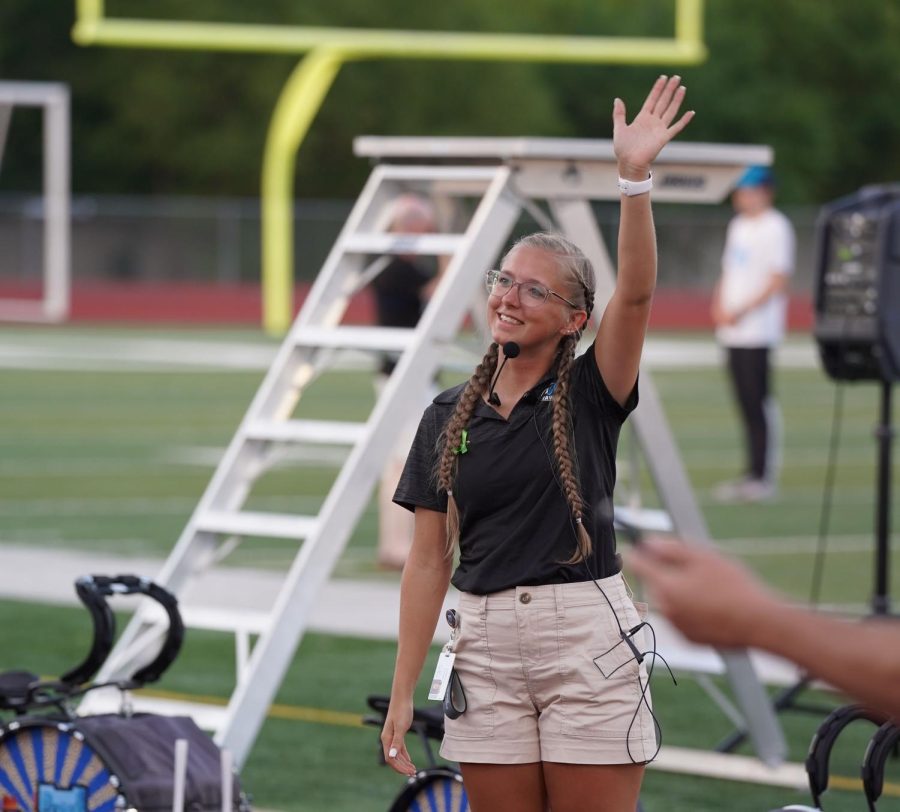 Assistant band director, Madison Hughes, waves to the band parents at the bands first parent preview for the 2022 season. Hughes hopes to create a lasting impact at the school and on the band as the first female band director. 