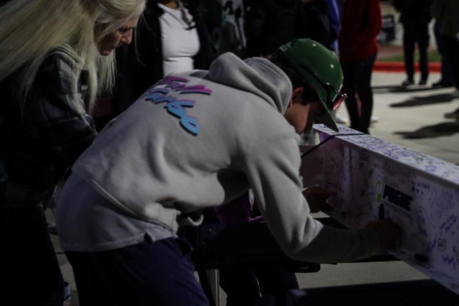 A student was seen signing a beam. 