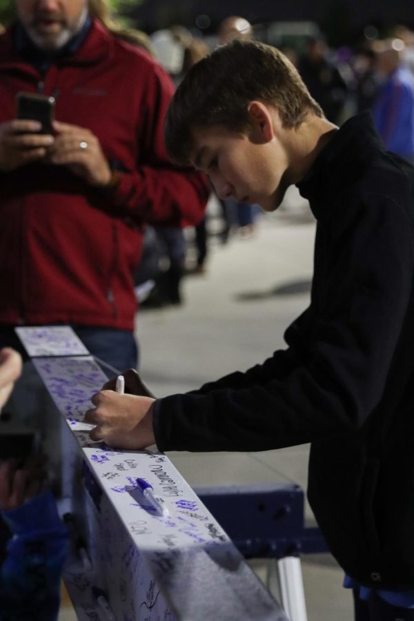 While signing the beam, PISD student marks his legacy on the third high school.