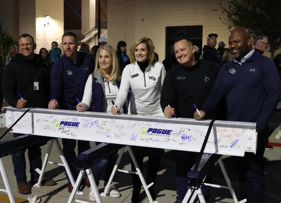 Current principal of Rock Hill, Dustin Toth and Prosper ISD board members Bill Beavers, Debra Smith, Holly Ferguson, Garrett Linker, and Drew Wilborn sign one of the four beams held at the event. "It's a great event and I'm so happy that we have started this tradition in PISD," Toth said. The beams will be transferred to the Walnut Grove construction site to be put up as soon as possible before opening up the school. 