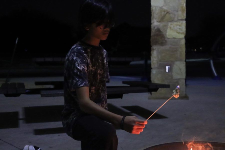 Freshman Zackery Dhakir Ali Tahir roasts a marshmallow for his friend. I enjoyed being here, Ali Tahir said, I love the vibes. After the bonfire, he joined MSA right away to be a part of all the fun. 