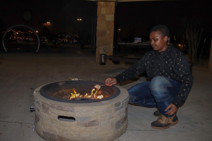 Freshman Kareem Kamal is getting ready to make a s'more by roasting a marshmallow by the bonfire. "I would invite all my friends to be a part of the whole program," Kamal said. After making the s'more, he remains excited about upcoming MSA events. 