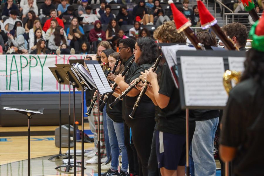 Senior Natasha Manoj plays the flute at the pep rally. Manoj is a flute section leader and has been a part of band throughout the entirety of her high school career.