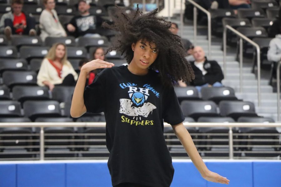In the middle of the dance, junior Talea Boston flips her hair as a dramatic twist to the dance. All the other dancers around her match each others energy and steps. 