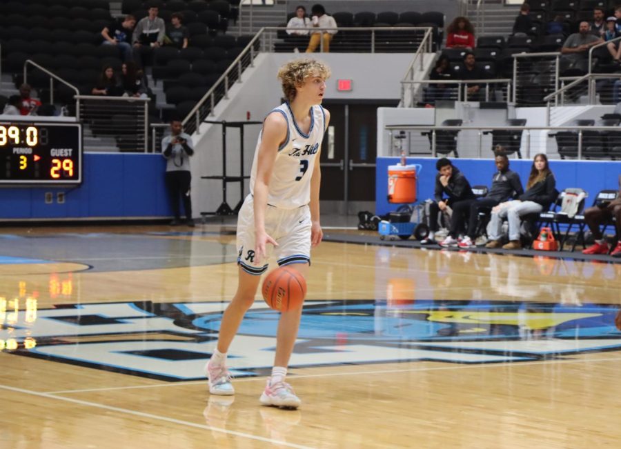 Locked in the game, senior Riley Shore tries to find a teammate to pass the ball to. In the current season, the Blue Hawks boys varsity team is 14-7, according to MaxPreps. Rock Hill played against Denton Braswell on Jan. 13. 