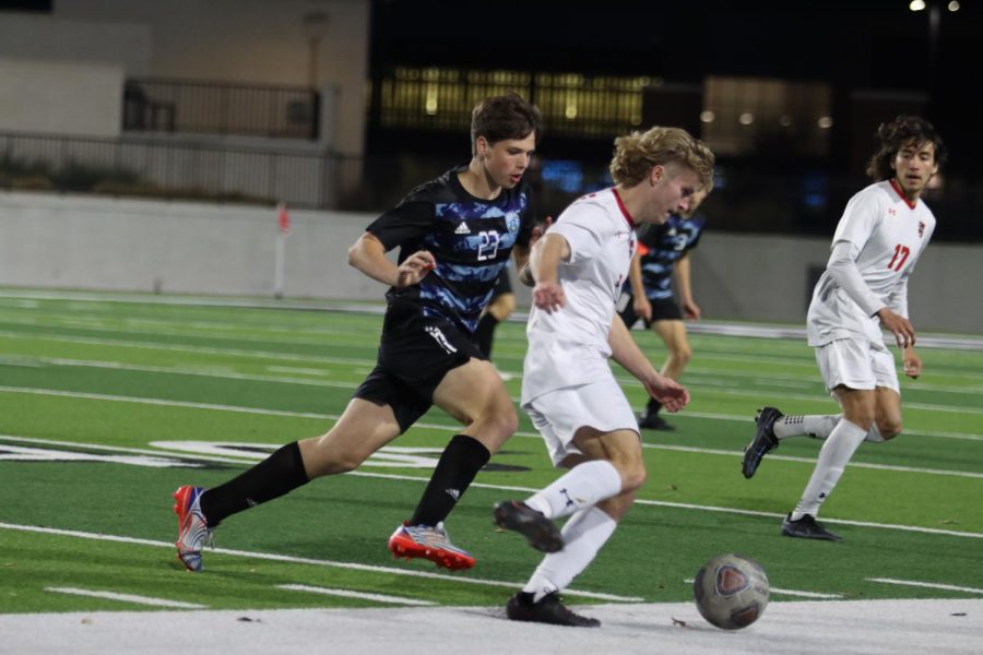 Sophomore Ethan Johnson attempts to stall as Braswell dribbles the ball toward the opposing goal. "I haven't played with my team too much so we didn't have the best team chemistry," Johnson said. "That was a challenge, but we have a lot of talent that's hopefully going to come together to make a run at playoffs."