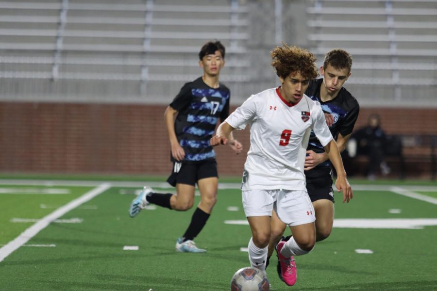 Senior midfielder Jake Loertscher closely follows a Braswell player with possession. "It was an intense game," Loertscher said. "We kept the pressure high for most of the second half, allowing us to tie the game in the last 17 seconds."  