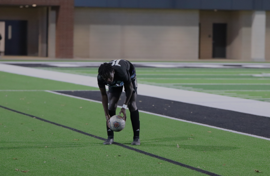 Senior defender Leshan Kantai picks up the ball after it is kicked off the sidelines. “The role I played was to be there for my teammates when we went down and lift us back up,“ Kantai said, “and I thought we did well in the second half coming from behind three times.”