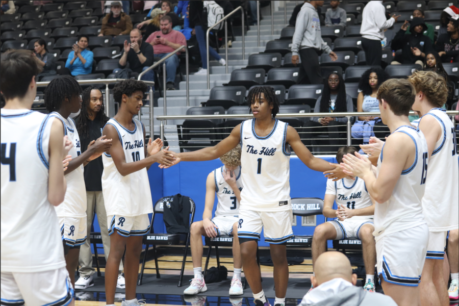 Hooper high-fives his teammates as he gets announced back into the starting lineup for the first time since having to sit out. His first game back was on Jan. 13 at home vs. Braswell. He went on to drop 13 points in his return.