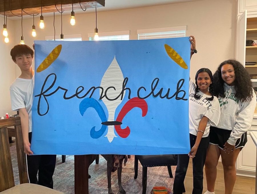 French Club members William Pan, Pranita Nagavishnu and Alexandra Thomas hold up a poster they created. "Every meeting is filled with engaging activities, amazing people and delicious food which made this club become one of my most active commitments," French Club copresident Nagavishnu said.