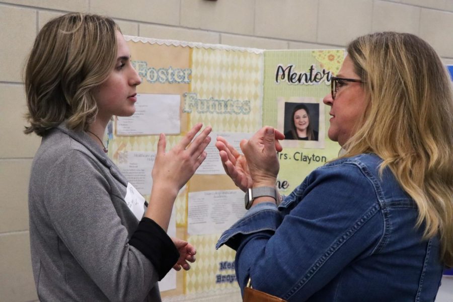 The Foster Futures display is shown by senior Megan Broyles (left). I learned that if you are admitted into foster care for even one night the state of Texas will pay for your college in full, junior Reagyn Harrington said. I thought it was really cool and really beneficial to those who are in foster care as its already difficult to apply for college when you are in foster care, but its even harder to find a steady income for college. 