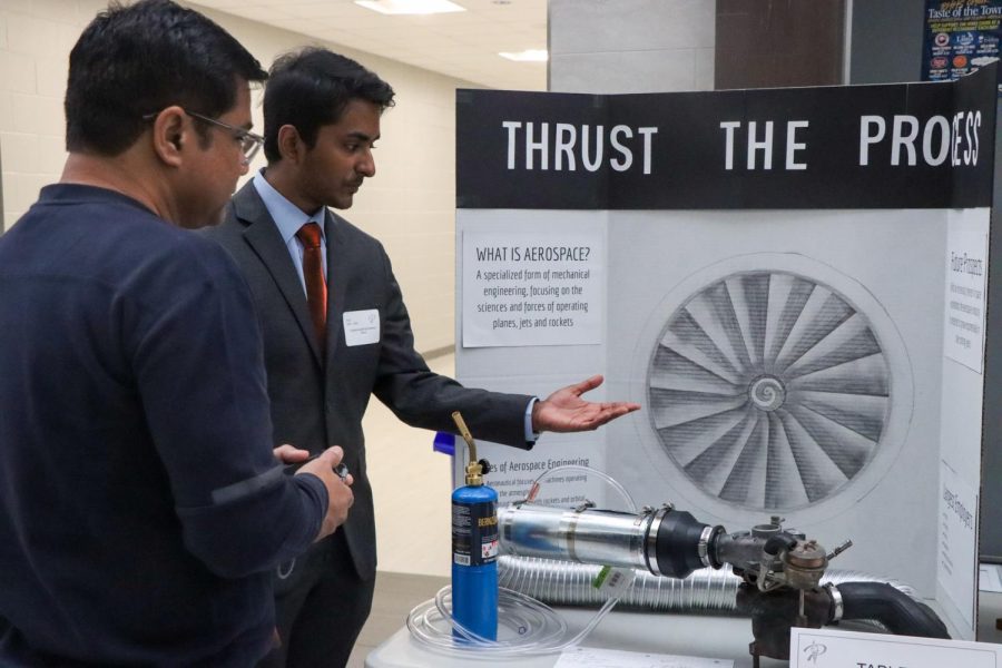 Showing all about aerospace Thrust the Process, senior Narain Kartheeswaran communicates his board to a guest to attended the event. 