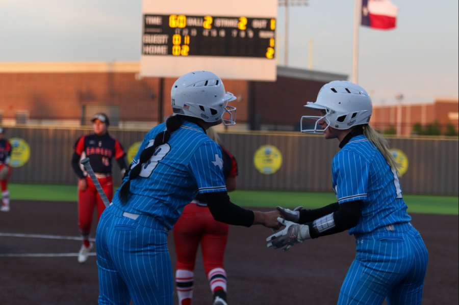 Junior Adrya Olivarez and senior Jolie Malan share a moment of celebration after the team's second run. "It was a pretty big game for us because we are trying to get to third place," Olivarez said.  "It was mainly about fighting and that want to get there. I think in the end it was just [a question of] who wanted it more."