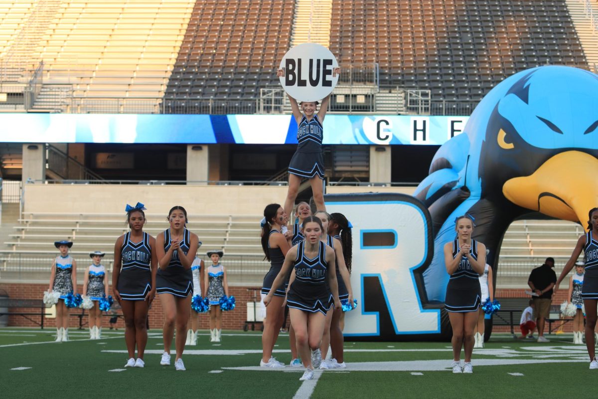 While holding up the “BLUE” sign high up in the air, the cheerleaders perform a magnificent show to the crowd. 