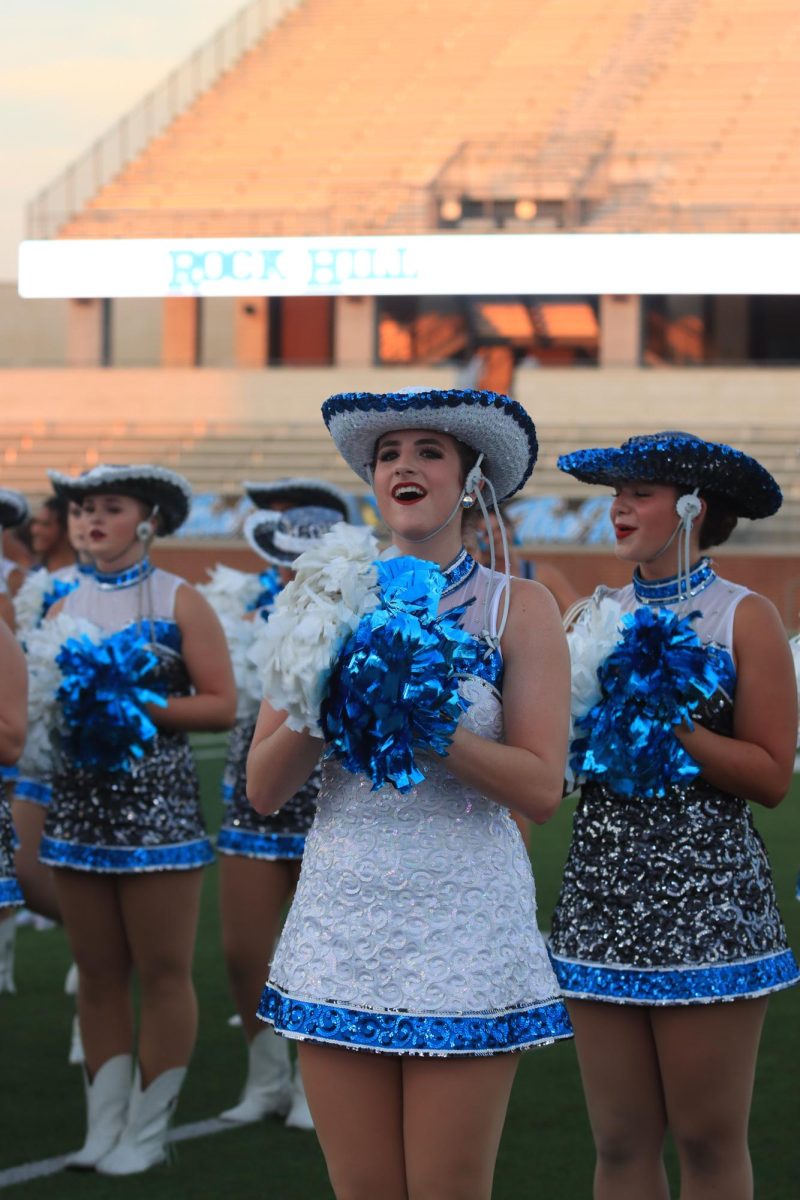 Holding her poms in her hands, senior Madison Rudnick stands with her fellow Rockettes awaiting to start the season. 
Rockettes