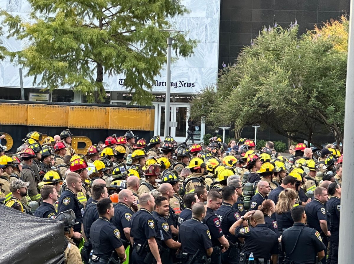 Gathering around, first responders are shown at the Dallas Memorial Stair Climb listening to announcers. “It symbolizes the dedication that those guys were willing to do that day; put their life on the line for a stranger, you know, and that's what we sign up for when we take the oath of a firefighter [or police officer,]" Firefighter Mark Parker said. This ceremony started at 8:00 a.m. on Saturday, Sept. 9. 