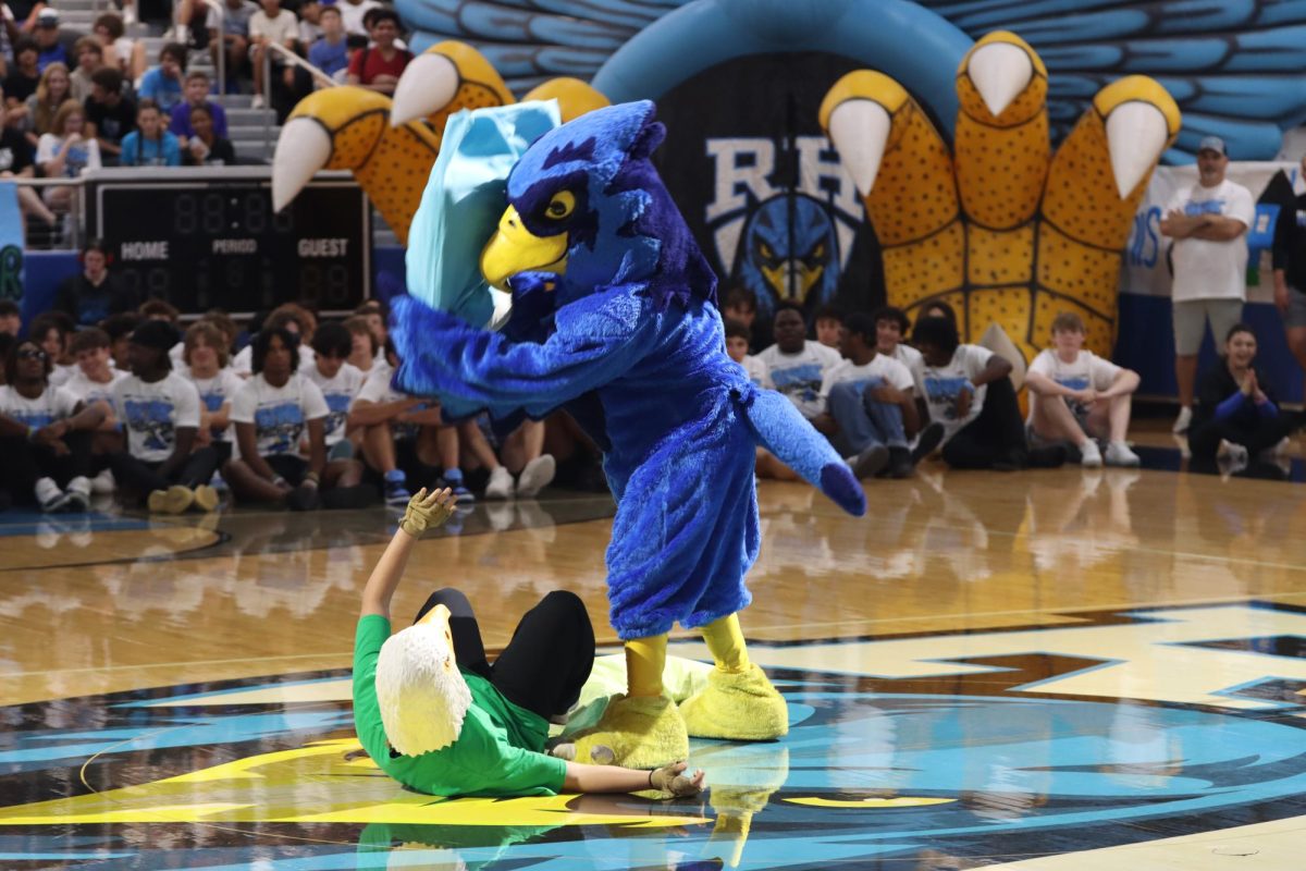 In preparation for the football game taking place at the Children's Health Stadium, the mascots from both schools dueled in a small battle during the pep rally. 