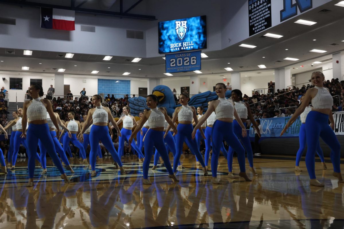 The student body applauds for the recital given by the Rockettes before performing at the varsity football game taking place later in the day.  