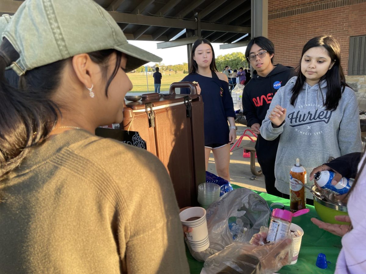 Junior and Compostify Student Outreach Director Sowmya Velayutham sells hot cocoa, spiced chai and brownies to high school volunteers. "Our fundraiser events are actually really fun," junior Harsha Kannappan said. "We bake our goods and sell them fresh."
