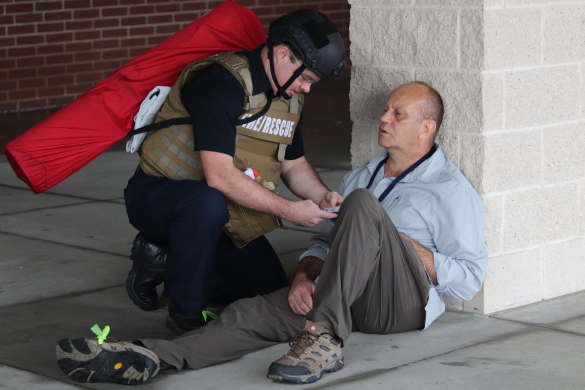 Mocking a fatal injury, a volunteer sits down while Prosper Fire and Rescue examines the operation badge. 
What’s critical for the community to understand is the relationships we are building here are critical for an event like this, Assistant special agent in charge with the Dallas FBI Geoff Mcguire said. We’ve exercised all of our abilities between local state and federal police departments, fire, EMS, all of those things, we showed that even if it were to happen we would quickly respond and act on a situation like this, and a community can understand that they would be safe. Many entities were present during this practice to ensure the safety and security of our community. 