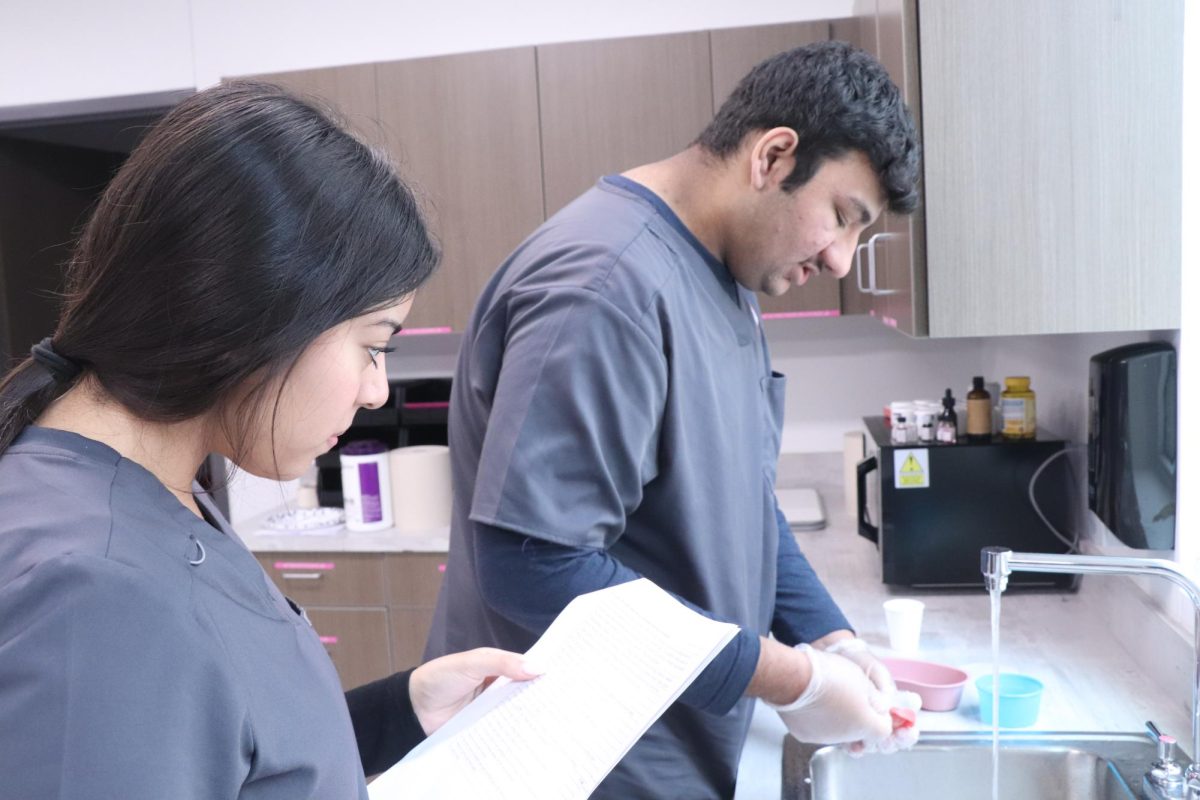 Senior Shelvy Cuenca and Junior Hamzah Sheikh are preparing for their lab on how to brush a patients teeth. When doing these skills we specifically learn about how to speak to a patient and make sure they are comfortable while completing the task at hand, Alexander said. 