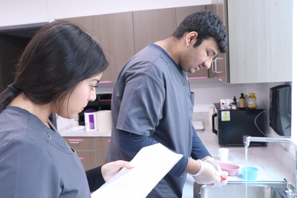 Senior Shelvy Cuenca and Junior Hamzah Sheikh are preparing for their lab on how to brush a patient's teeth. "When doing these skills we specifically learn about how to speak to a patient and make sure they are comfortable while completing the task at hand," Alexander said. 