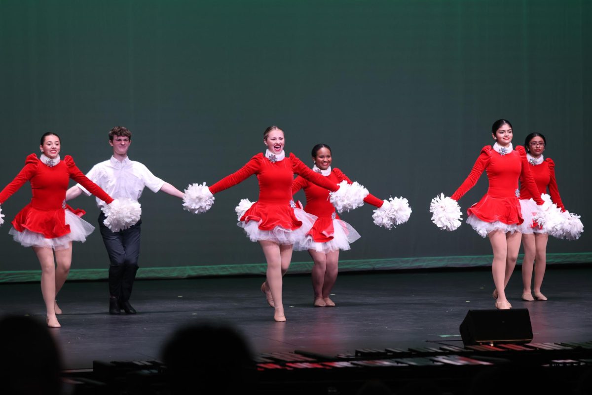 Dancing with their festive style, the junior varsity Dazzlers personalized their performance with the holiday spirit. 